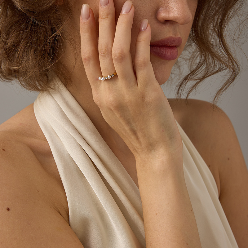 Newly designed, stylish 18k gold and stainless steel ring with pearl and zirconia inlays - versatile and classic jewelry accessory.